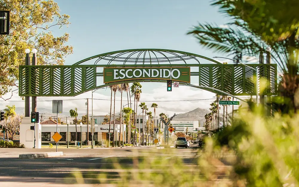 The Escondido arch sign over Grand Avenue, lined with palm trees