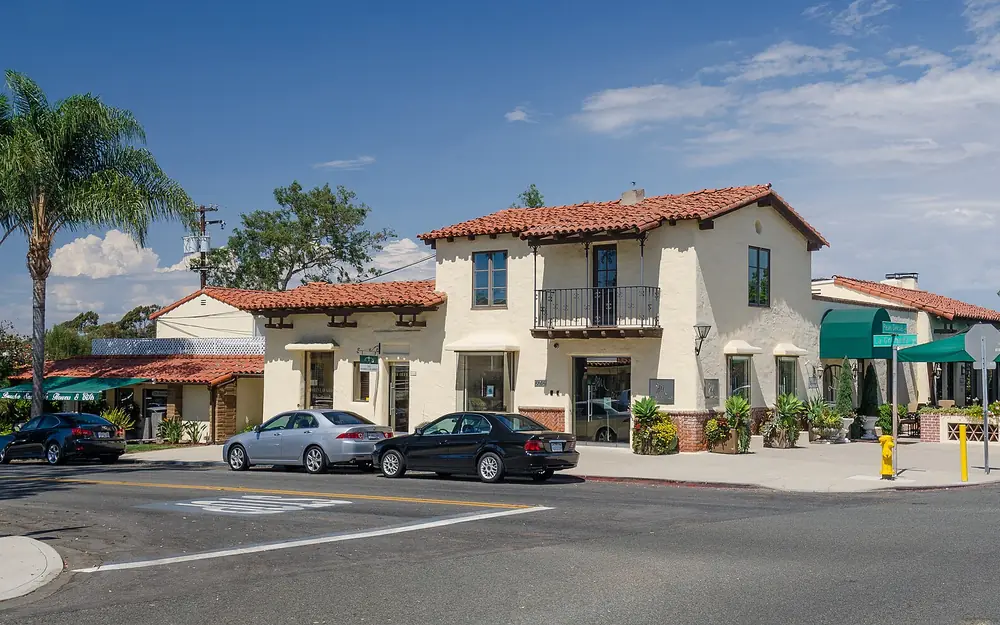 Spanish-style buildings with red tile roofs on a street in Rancho Santa Fe