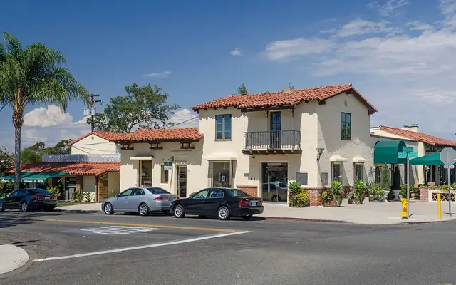 Spanish-style buildings with red tile roofs on a street in Rancho Santa Fe