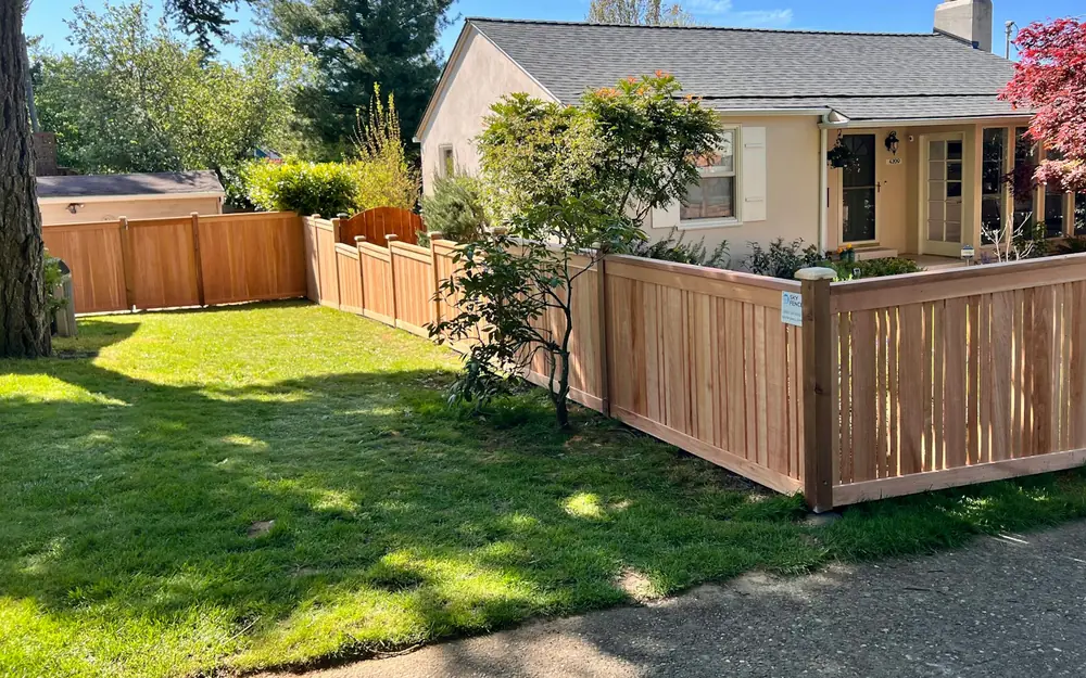 A new wooden fence around the yard of a house
