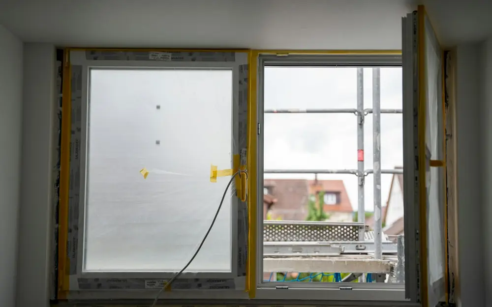A new window part-way through installation, with scaffolding outside